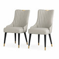 Conjunto de 2 sillas de cuero sintético beige con patas metálicas negras y detalles dorados